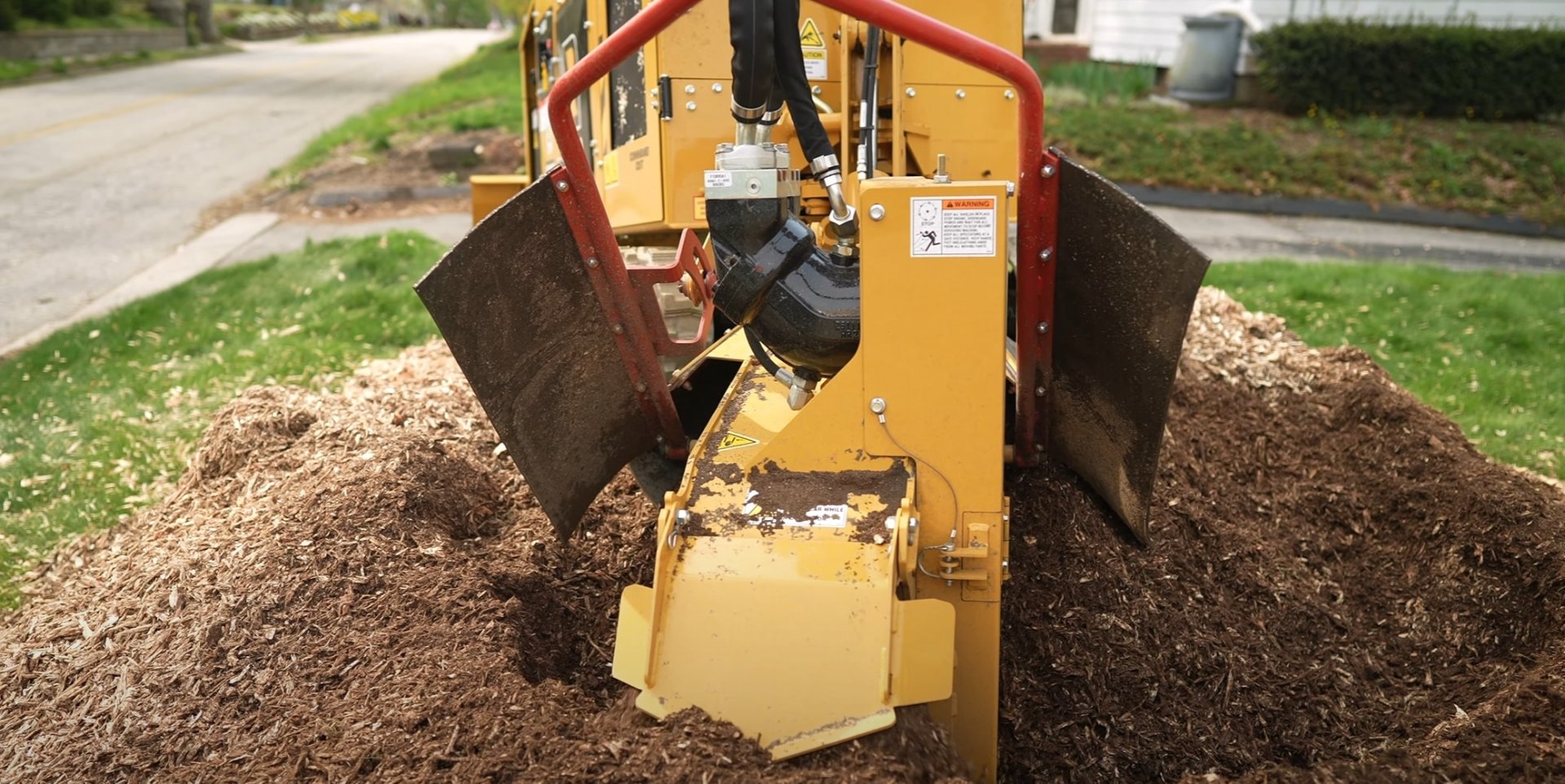 Professional Stump Grinding Equipment Heavy-duty stump grinding equipment removing tree stumps from residential property